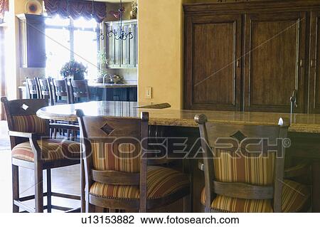 Stock Image - Bar with tall chairs. Fotosearch