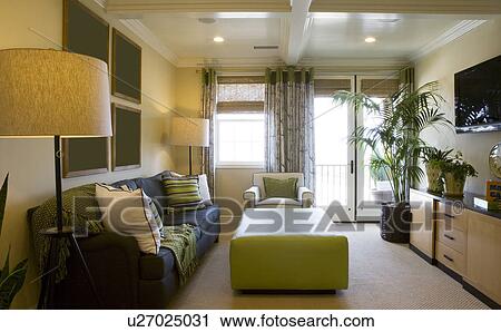 Stock Image - Contemporary living room with wall mounted tv. Fotosearch