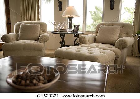 Stock Image - Detail of two chairs with lamp and table. Fotosearch