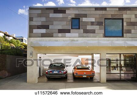 Stock Photograph - Exterior of Modern Home Garage and Cars. Fotosearch