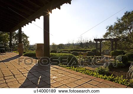 Stock Photo - View of Courtyard from Spanish Style Porch. Fotosearch