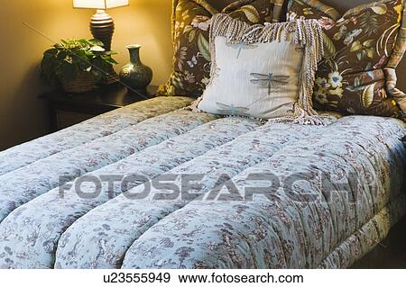 Stock Photo - Comfortable Double Bed with Comforter. Fotosearch