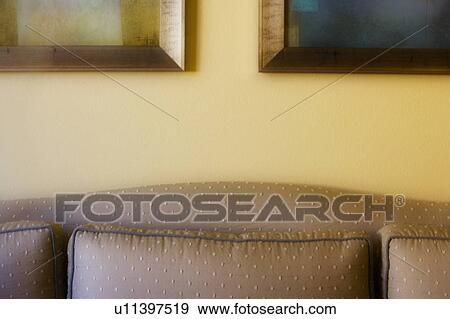 Stock Photo - Cozy Couch with Paintings. Fotosearch