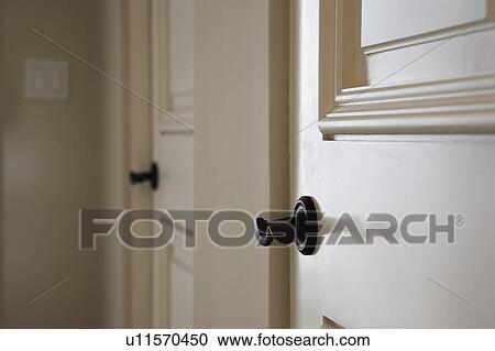 Stock Image - Detail of two doors with black handles.. Fotosearch