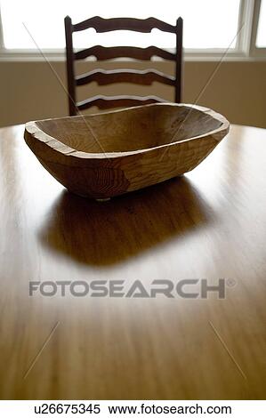 Stock Photography - Detail of wood table and chair with wood center piece.. Fotosearch