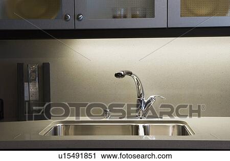 Stock Image - Kitchen Faucet and Sink. Fotosearch