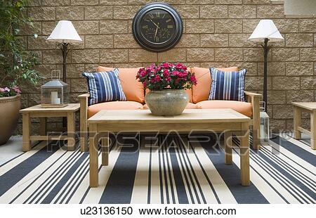 Stock Image - Outdoor patio with teak furniture. Fotosearch