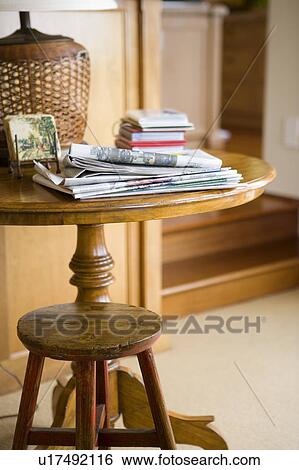 Stock Photograph - Stool and table with newspaper. Fotosearch