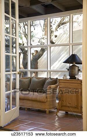 Wicker couch in front of window View Large Photo Image Stock Image - Wicker couch in front of window. Fotosearch