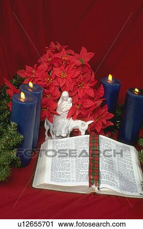 Stock Image - Bible advent candles pointsiettas and Lliadro porcelain figurine of Mary holding Jesus on the donkey. Fotosearch