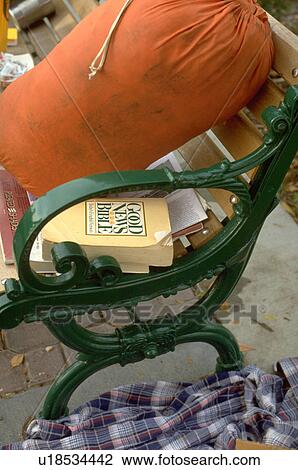 Stock Image - Bible and sleeping bag on a bench. Fotosearch