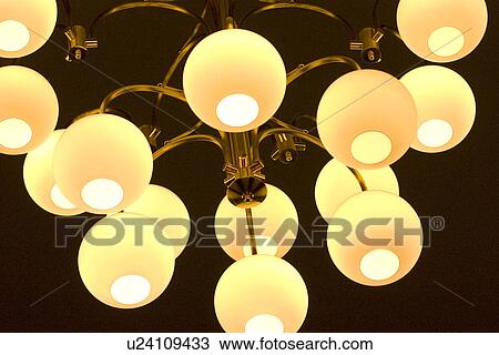 Stock Image - Chandelier light in Polish Catholic church. Lodz Central Poland. Fotosearch