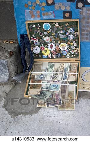 Stock Image - Display of buttons coins and paper money. Fotosearch