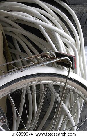 Picture - Electrical wiring and bicycle wheel. Fotosearch