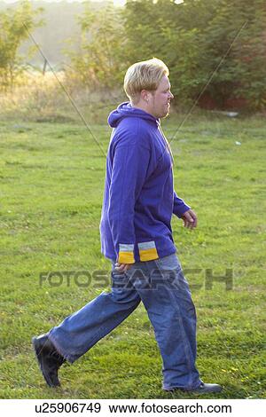 Man walking in the Polish countryside View Large Photo Image Stock Photo - Man walking in the Polish countryside. Fotosearch