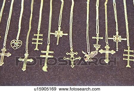Stock Photo - Necklaces with crosses set out for sale at flea market. Fotosearch