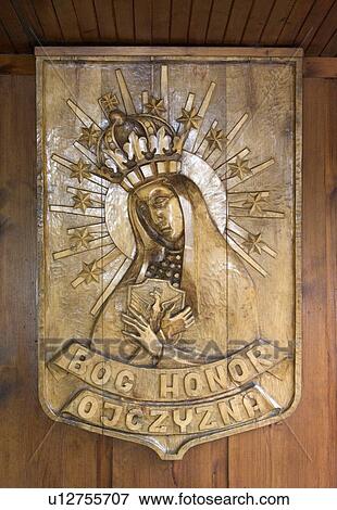 Stock Photo - Polish wood relief of Virgin Mary at The Wooden Church, Spala, Poland. Fotosearch