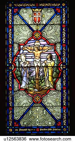 Stock Photograph - Stained glass window of Jesus on the Cross. Fotosearch