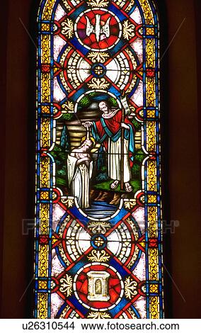 Picture - Stained glass window of John the Baptist baptizing Jesus in the river. Fotosearch