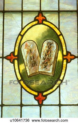 Stock Photograph - Ten commandments on stained glass at Holy Communion church. Fotosearch