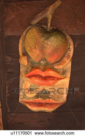 Stock Image - Wooden carving Adam Eve the tree of life and the serpent at an outdoor market. Biskupin Poland East Eastern Europe. Fotosearch