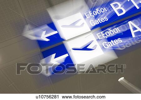 Stock Image - Close-Up, Alphabet, Blurred Motion, Blue, Arrow Sign, Airport. Fotosearch