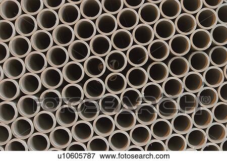 Stock Photo - ducts, pipes, corrugated, pile, stack, stacked. Fotosearch