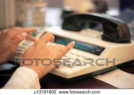 Stock Image - A TTY or TDD machine/device being utilized to communicate via telephone with a person who is deaf or has a hearing impairment.. Fotosearch