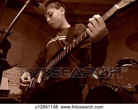 A young boy with diabetics enjoys playing on his guitar. View Large Photo Image Stock Photo - A young boy with diabetics enjoys playing on his guitar.. Fotosearch