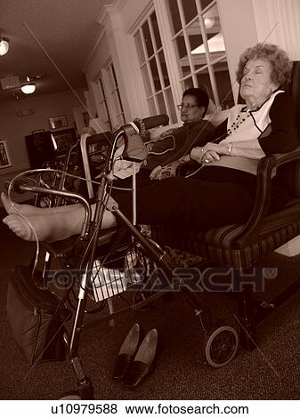 Stock Photo - An elderly person rests their feet on a walker.. Fotosearch