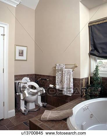 Beautiful bathroom in an exquisite home featuring universal design - totally accessible for those with disabilities - including a toilet lift seat for those individuals requiring assistance in lifting from a seated position. View Large Photo Image Stock Photography - Beautiful bathroom in an exquisite home featuring universal design - totally accessible for those with disabilities - including a toilet lift seat for those individuals requiring assistance in lifting from a seated position.. Fotosearch