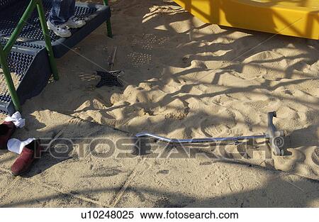 Stock Photography - Image of canes and shoes that have been left behind while their owner plays in the sand with other kids.. Fotosearch