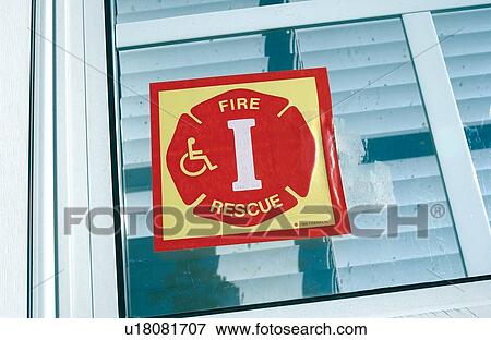Symbol or Icon placed on the bedroom window of a person with a disability. This symbol alerts fire and emergency personnel, in the even of an emergency, that a person with a disability is residing in this area, and will need assistance. View Large Photo Image Stock Photo - Symbol or Icon placed on the bedroom window of a person with a disability. This symbol alerts fire and emergency personnel, in the even of an emergency, that a person with a disability is residing in this area, and will need assistance.. Fotosearch