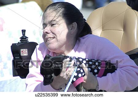 Woman (power wheelchair user) gives her dog a ride View Large Photo Image Stock Photo - Woman (power wheelchair user) gives her dog a ride. Fotosearch