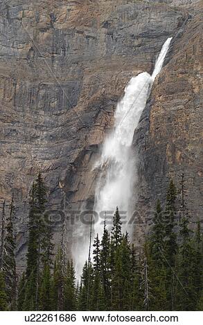 Stock Photograph - A waterfall in the mountains, Rocky Mountains, Canada. Fotosearch