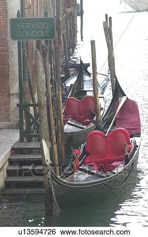 Array of gondolas docked at a canal in Venice, Italy View Large Photo Image Stock Photograph - Array of gondolas docked at a canal in Venice, Italy. Fotosearch