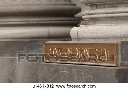 Stock Image - Bank name on a stone pillar of a building in Montreal, Canada. Fotosearch