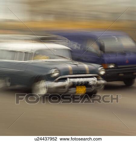 Blurred view of a car and a van on a road, Havana, Cuba View Large Photo Image Stock Image - Blurred view of a car and a van on a road, Havana, Cuba. Fotosearch