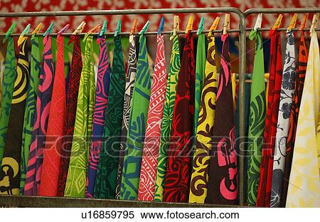 Bright colored fabrics hung from a rack at the straw market View Large Photo Image Stock Photography - Bright colored fabrics hung from a rack at the straw market. Fotosearch