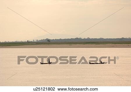 Stock Image - Canoes on the Irrawaddy River. Fotosearch