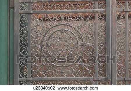 Stock Image - Close-up of a metal crafted door of an establishment in Montreal, Canada. Fotosearch
