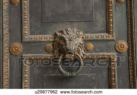 Stock Image - Close-up of an ornate door knocker on a door, Havana, Cuba. Fotosearch
