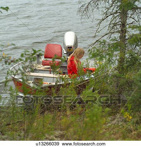 Girl sitting on edge of boat View Large Photo Image Stock Photo - Girl sitting on edge of boat. Fotosearch