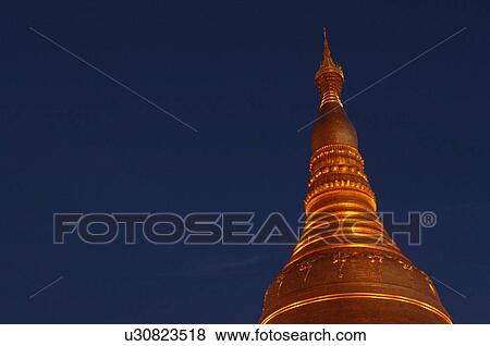 Stock Photo - Golden Stupa at night. Fotosearch