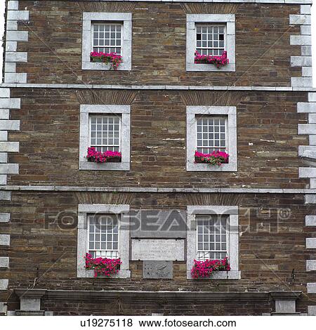 Stock Photo - Ireland – wall of buildings on street in Irish town. Fotosearch