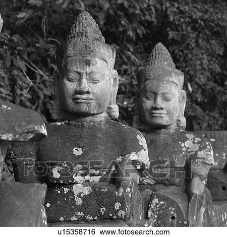 Stock Photograph - Large Buddha statues at the Khmer Kingdom palace ruins. Fotosearch
