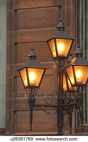 Lit lamp post on the streets View Large Photo Image Stock Photo - Lit lamp post on the streets. Fotosearch