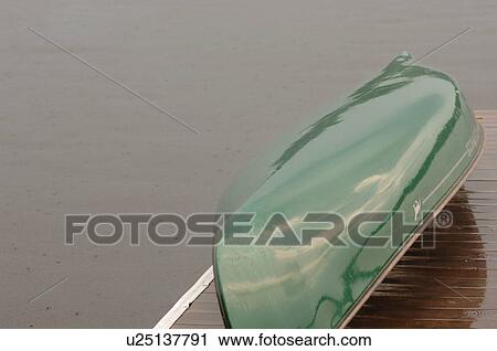 Stock Image - Overturned boat on a dock. Fotosearch