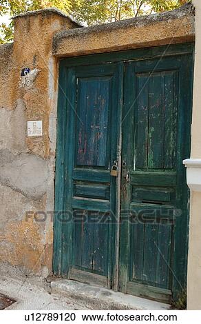 Stock Image - Pad locked wooden door on an ancient house in Athens, Greece. Fotosearch