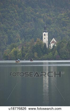 Panoramic view of boats on a lake in Slovenia View Large Photo Image Stock Photograph - Panoramic view of boats on a lake in Slovenia. Fotosearch